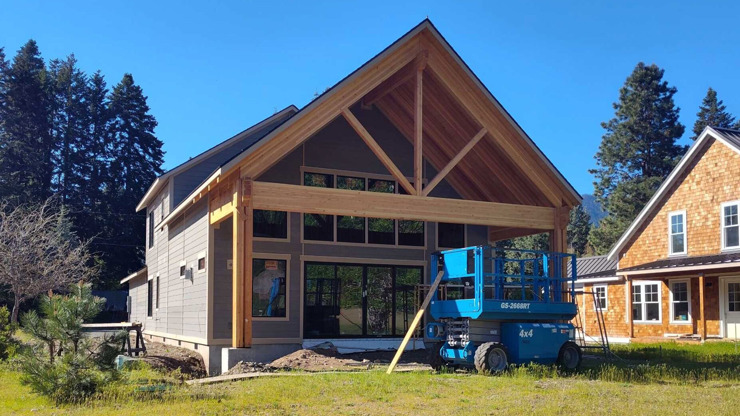Home in framing with construction equipment in front