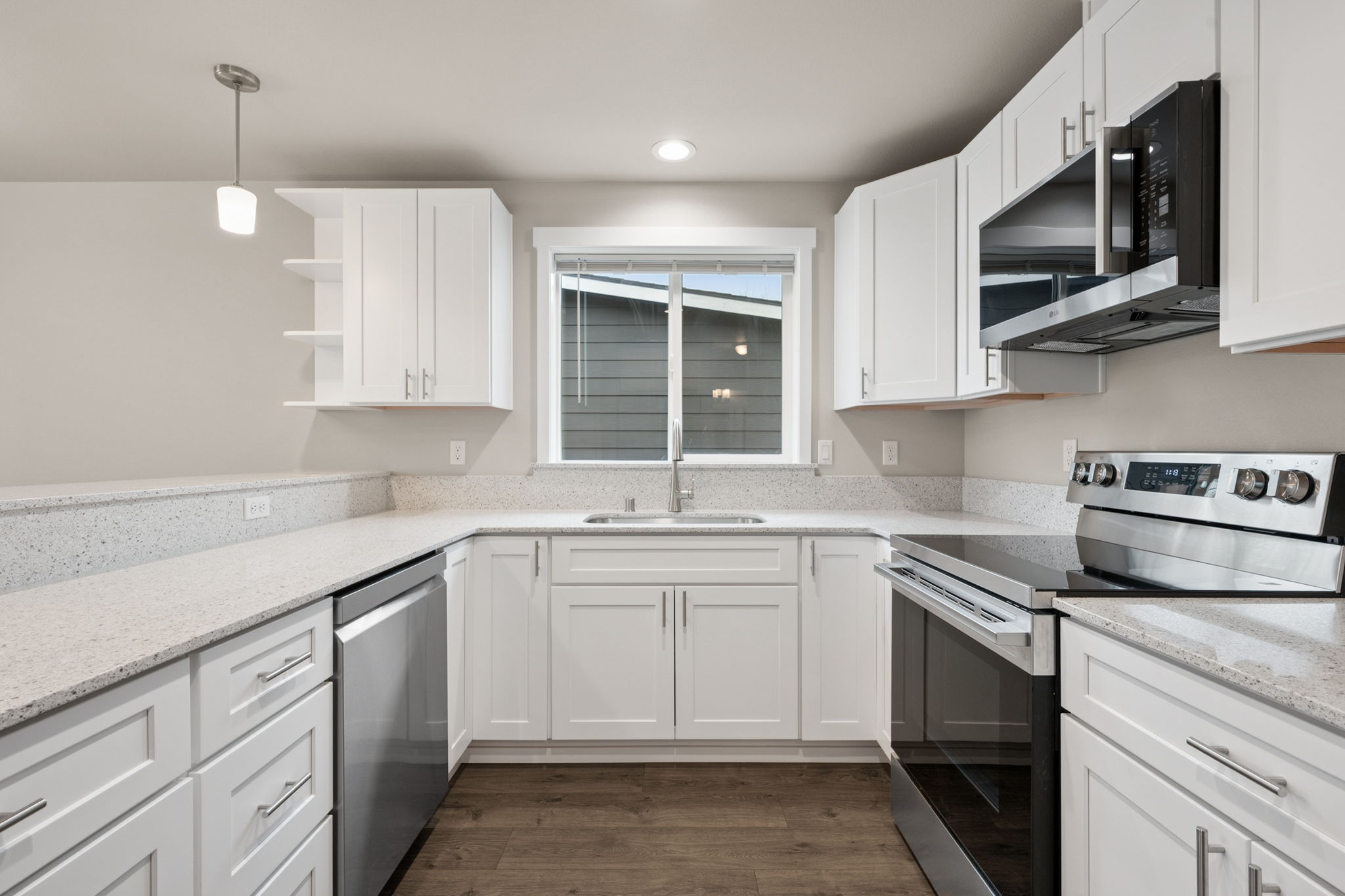 founders Collection kitchen — white cabinetry with quartz countertops and stainless appliances